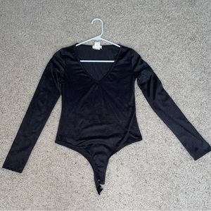 Medium long sleeve body suit. Soft almost like a suede material.
